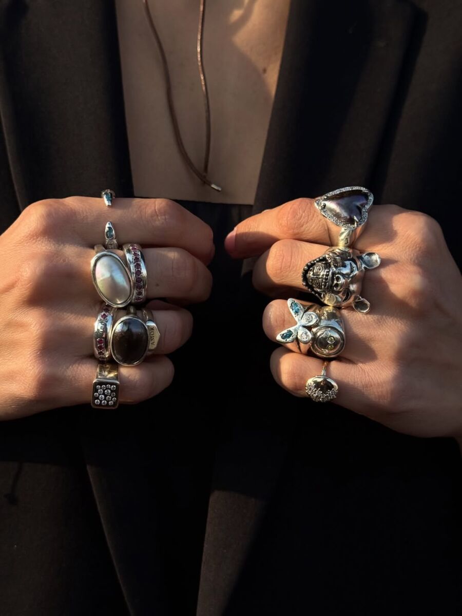 Manos de hombre modelando anillos grandes de plata