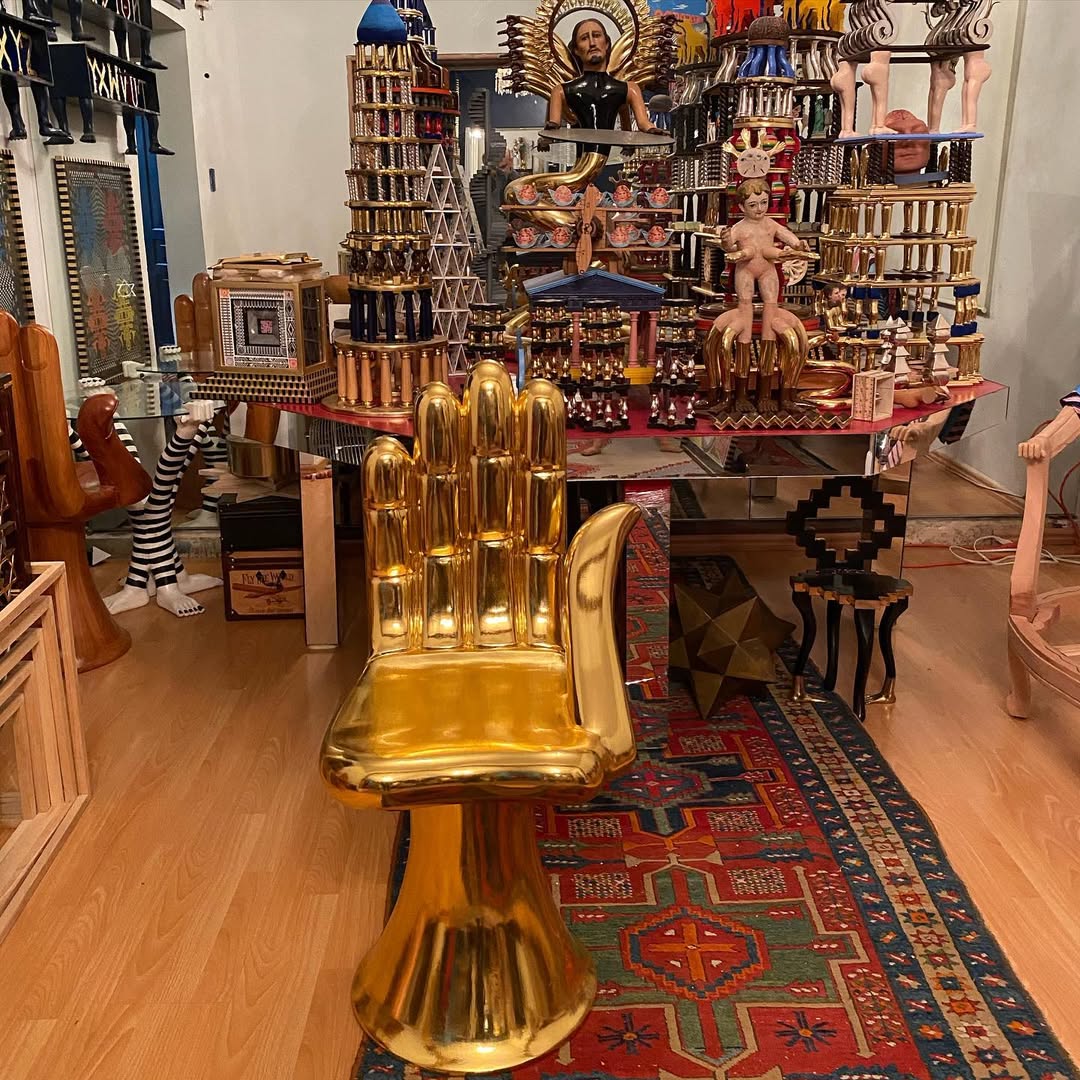 silla en forma de mano pintada en color dorado 