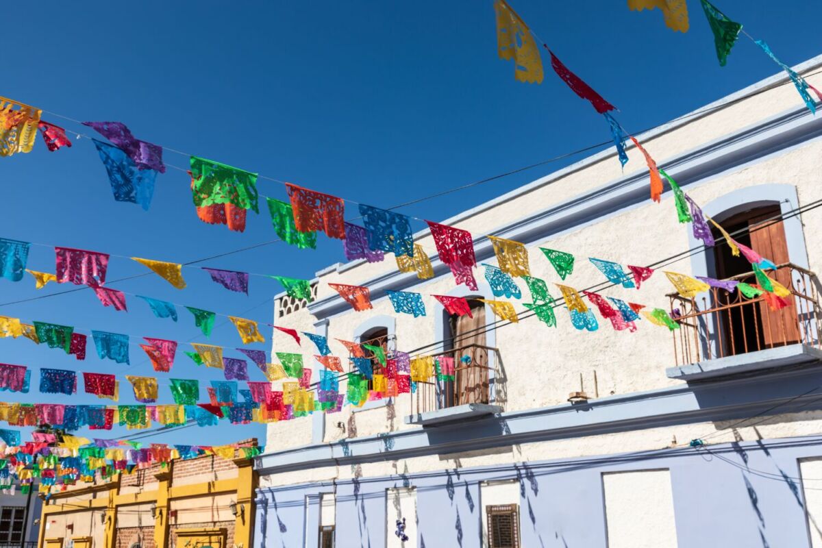 calle con casas coloridas y papel picado 