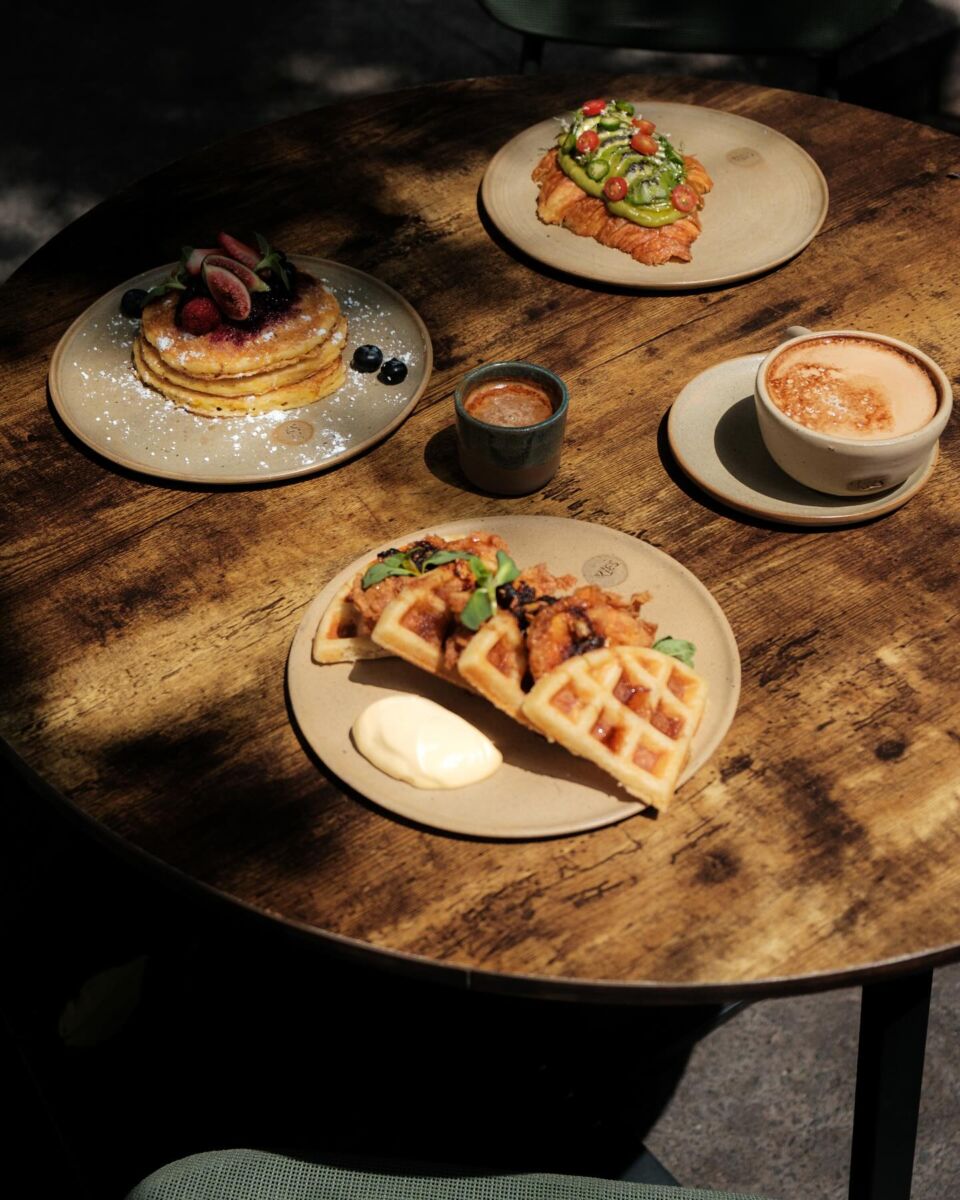 mesa con desayunos: wafles, hot cakes y croissant