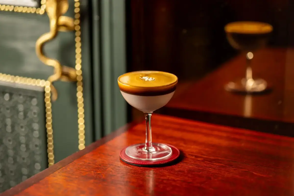 coctel en copa clásica en una mesa de madera elegante