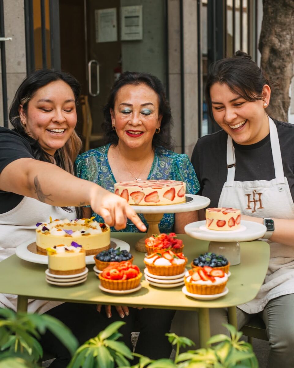 madre y dos hijas adultas comiendo pastel