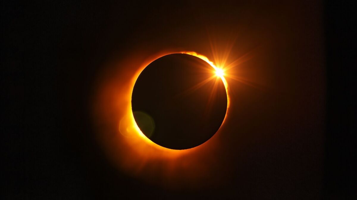 luna sonriendo al sol durante un eclipse