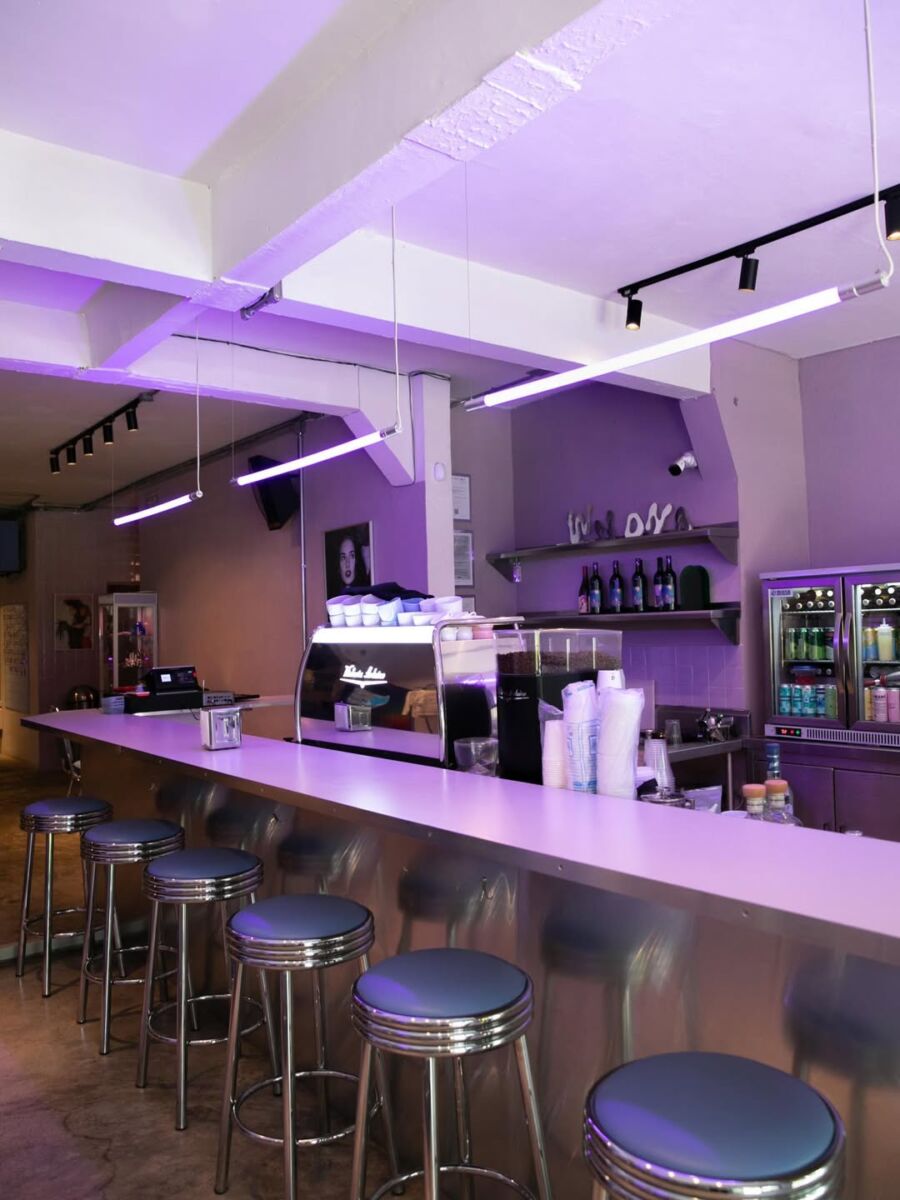 cafeteria retro con bancos color pastel y luces neon