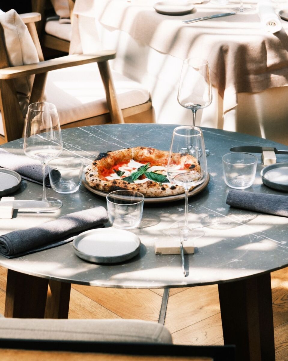 mesa con pizza y copas de cristal